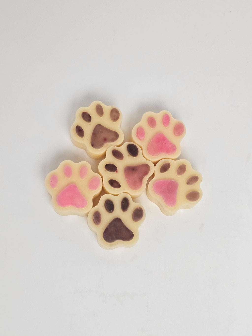 Paw print wax melts with pink and brown paw pads.